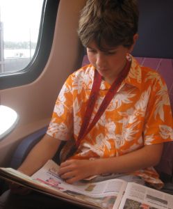 Boy reading newspaper