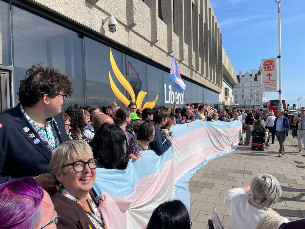 Hundreds stand with long trans flag in show of solidarity