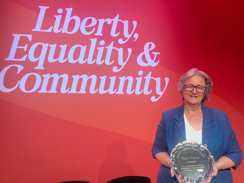 Ruth Dombey holding Patsy Calton Award