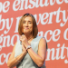 Jane Dodds on Conference stage in front of banner saying "none shall be enslaved by poverty, ignorance or conformity"